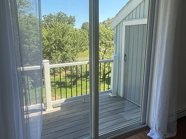 Private deck with small storage space attached to unit.