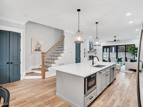 Spacious kitchen island with stainless steel appliances and large double sink with disposal.