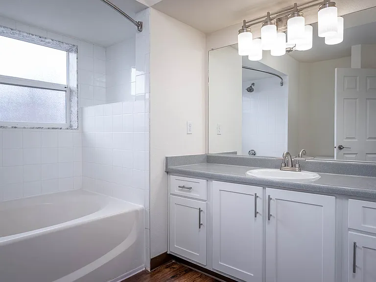 Village at Main Street | 2x2 Bedroom One Bathroom with White Cabinetry and Large Mirror