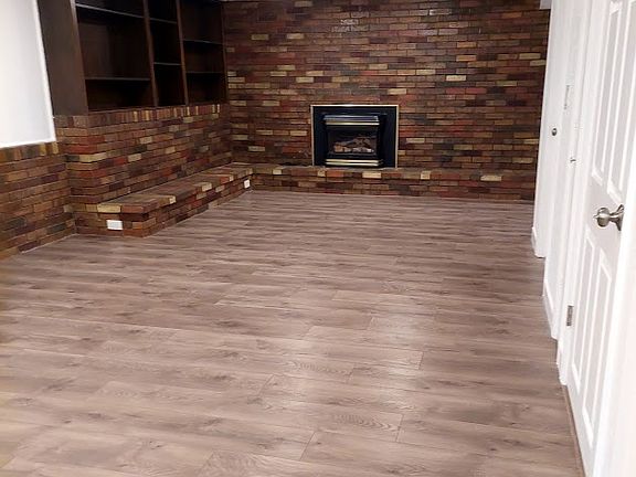 The living room includes build in shelves and a gas fireplace.
