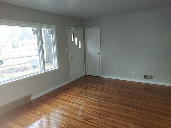 Living room w/ front window and door