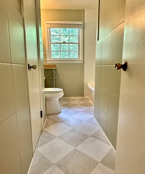 Newly renovated full bath upstairs with a tub and shower.