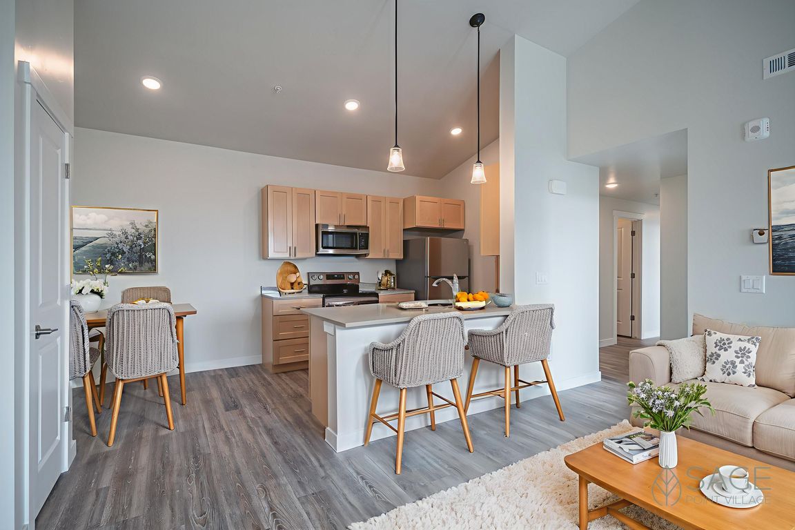 Sage Point Village Apartments - Staged Photo of Living Room, Dining Room and Kitchen