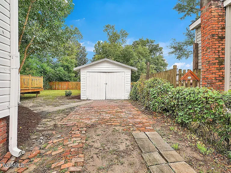 *original listing photo from when we purchased the home (garage and driveway)