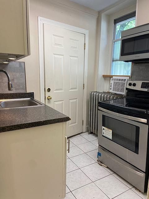 Kitchen with stainless steel appliances and microwave