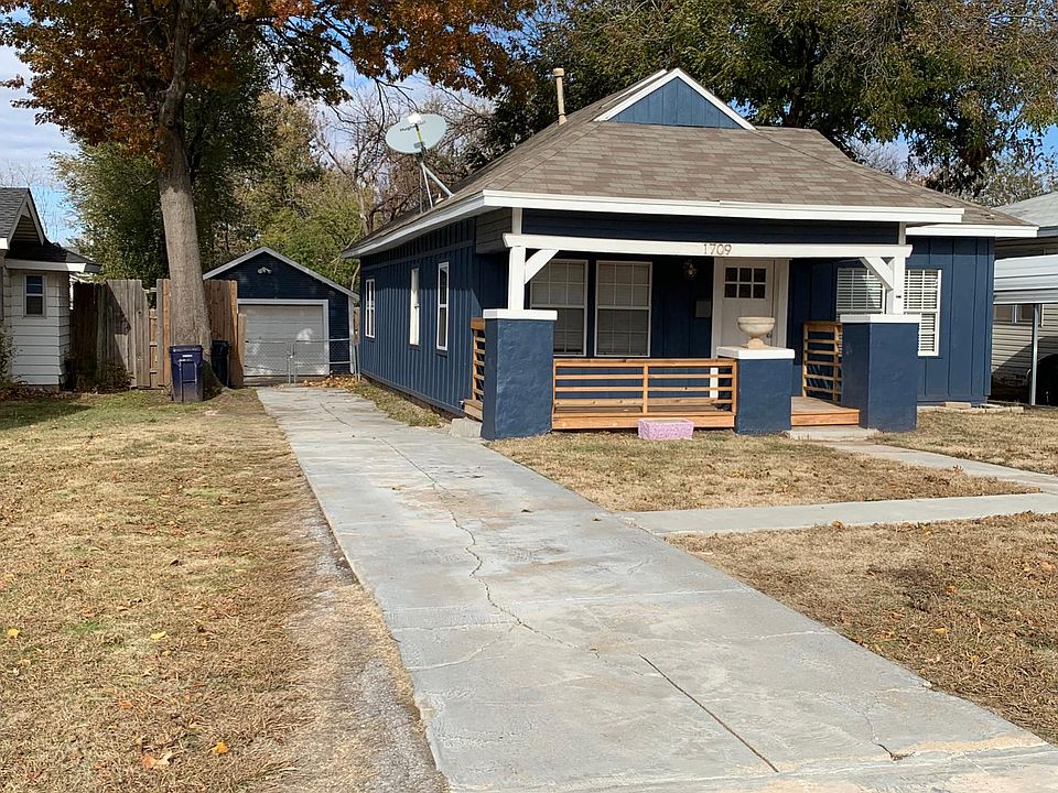 Home has nice size porch w/new railings_ Exterior plug-in for hanging lights for the summer time gatherings or for Christmas lights. A nice long driveway leading to a one car garage along with can lights in the eaves which offers lots of light in the driv