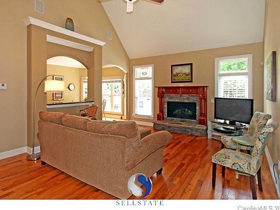 Oak Mantel with natural stone. Don't miss the curved walkway arches.