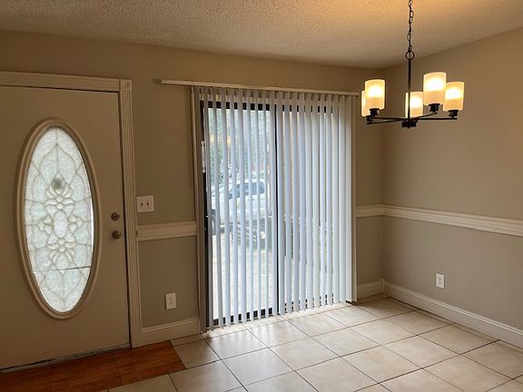 Dining Room looking toward the front door and patio sliding doors.