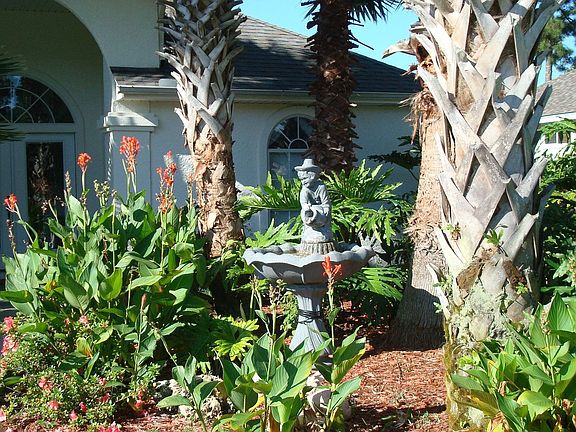 Large covered front porch overlooking fountain