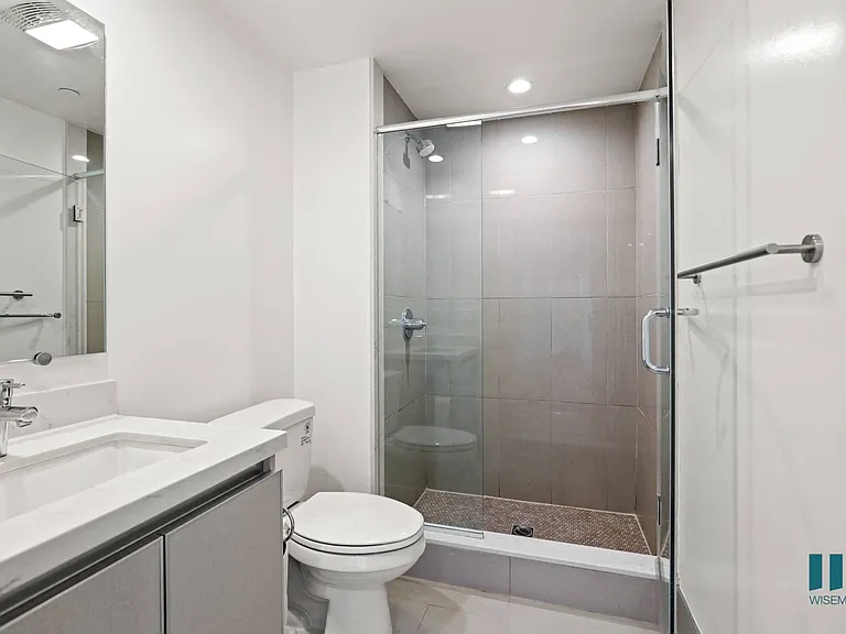 Bathroom with Stand-In Shower and Glass Door and Vanity Cabinet Storage