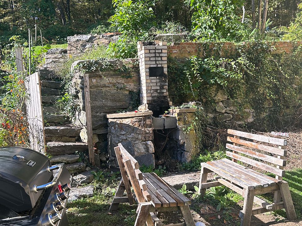 Fire Pit w/ stone staircase leading to upper terrace yard