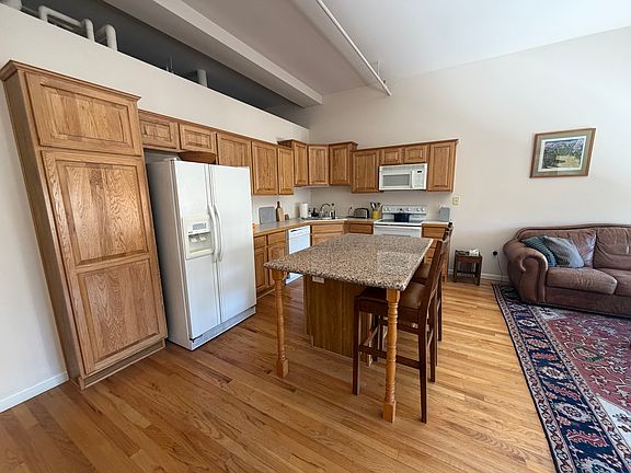 Kitchen has full stove, microwave, dishwasher, fridge and garbage disposal. Furnished with dishware, flatware, cookware and small appliances like toaster and coffee machine. Upgrades to gray quartzite countertops anticipated for completion by 4/1 move in.