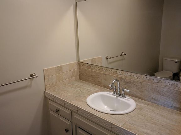Bathroom downstairs for guests. Five foot wide vanity with push-on push-off sink stopper.