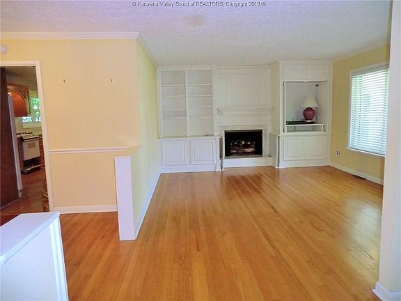 Living Room with nice built-ins and fireplace to Dining to Kitchen