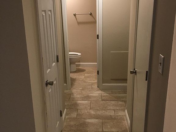 Hall leading to bedrooms and bathroom. Storage closets on each side of hallway.