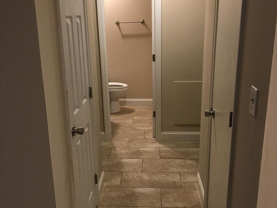 Hall leading to bedrooms and bathroom. Storage closets on each side of hallway.