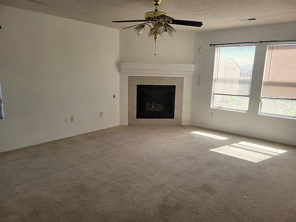 Living room w/ natural lighting. Big enough to fit to comfortable couches!