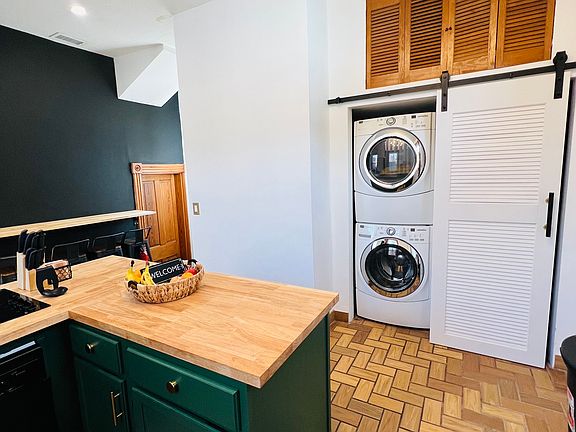 Washer/Dryer and Fridge behind movable barn door
