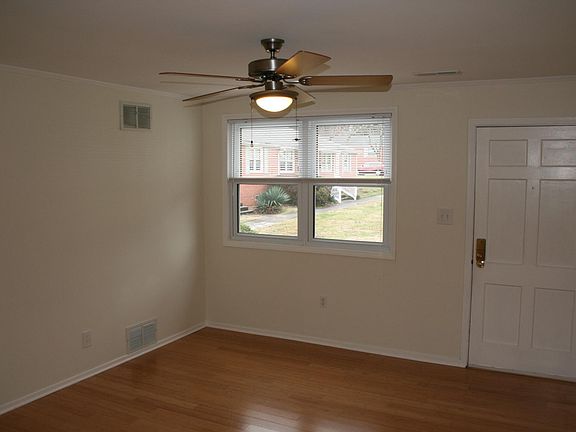 Living room view showing door with electronic keypad.