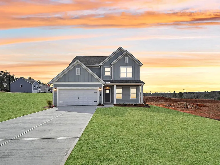 Exterior of the Alexander, two story home with a private driveway and attached garage.