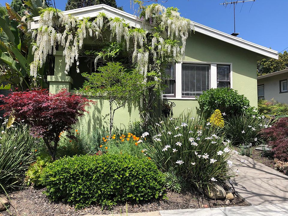 Front of house, tended by gardener and automatic irrigation system.