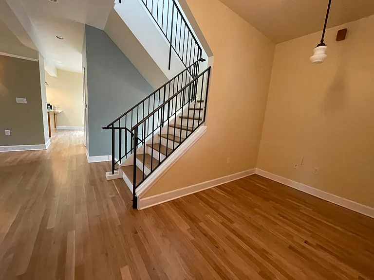 office on main floor with central stairway leading to bedrooms--the primary bedtroom is upstairs and 3 large bedrooms downstairs. Tall ceilings everywhere!