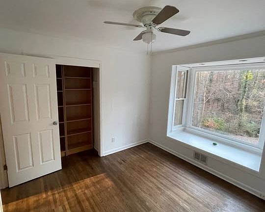 Study includes bench seat with large picture window with views of the creek and woods