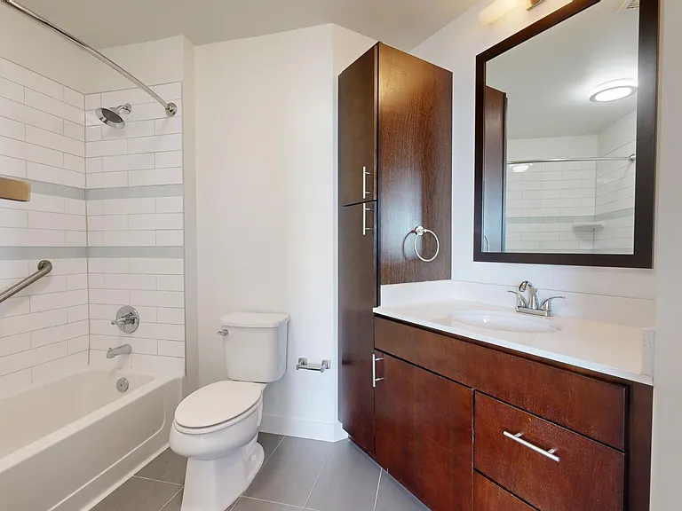 Apartment bathroom with tile flooring.