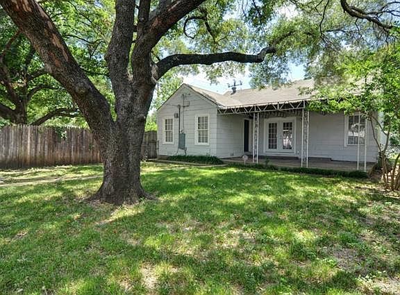 Backyard with fence and covered patio. Garage not in view in
