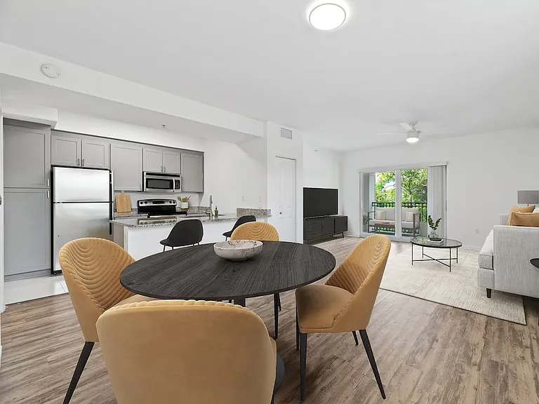 Renovated Package I dining and living room with hard-surface vinyl plank flooring
