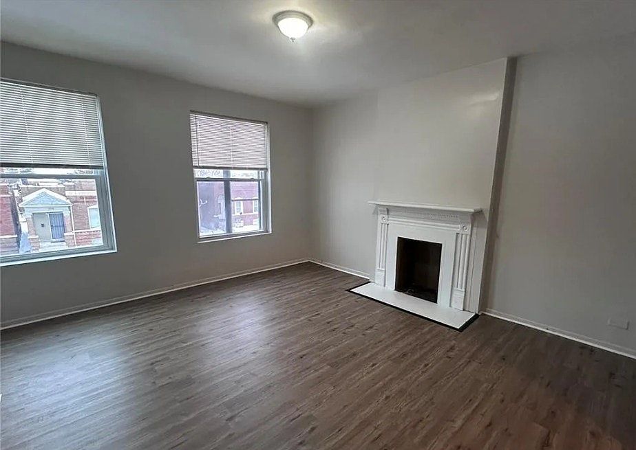 Bright living area with decorative fireplace and natural light