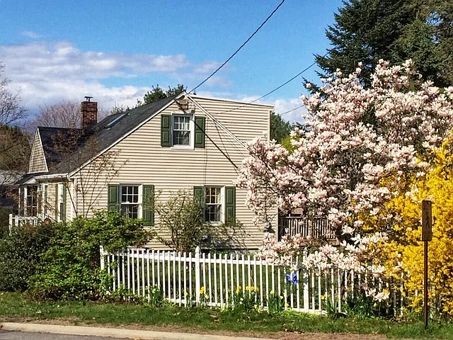 Mature landscaping, maintained by landlord, includes many flowering trees, flower beds, and several berry bushes (raspberries, black raspberries, and blackberries).