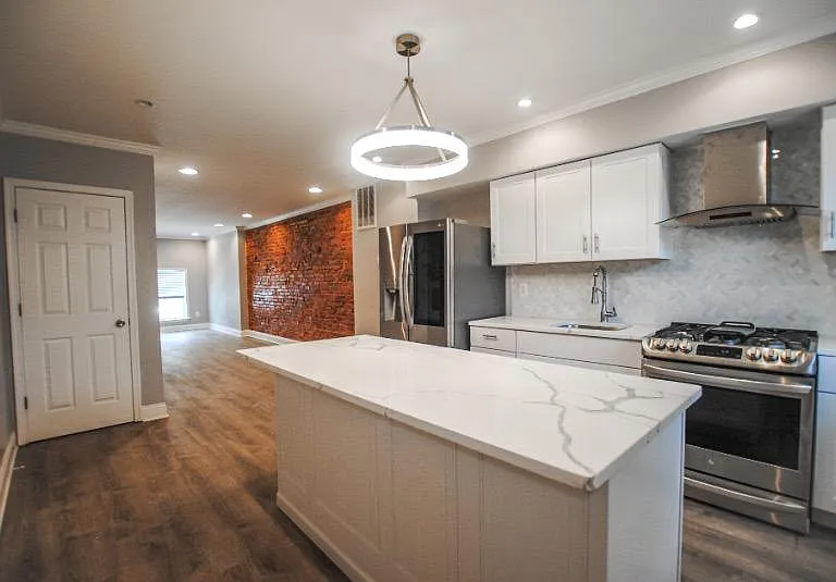Walk in to an open first level; head to the back of the house to find the upgraded kitchen