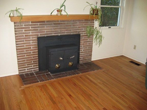 The wood-burning fireplace with the insert - and the gorgeous hardwood floor that has just been refi