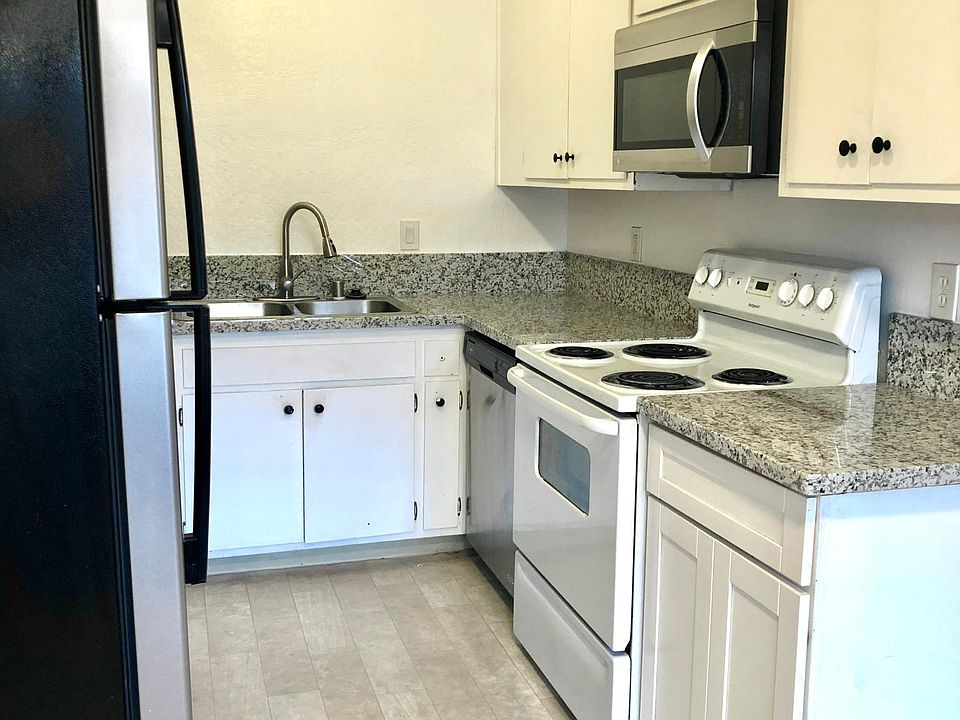 Remodeled kitchen includes dishwasher, microwave, stone countertops