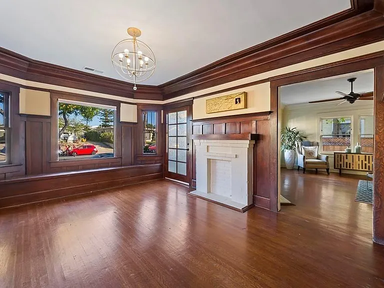 The home's charming dining room with a bay window and additional entrance