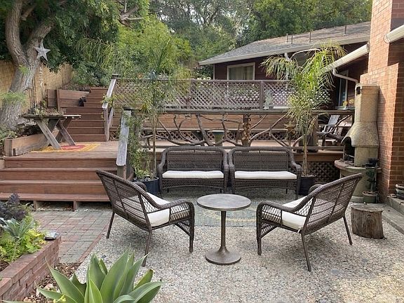 Lower patio with wicker benches outside back door
