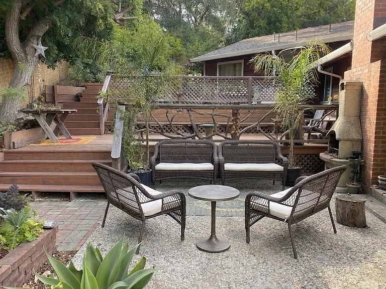 Lower patio with wicker benches outside back door