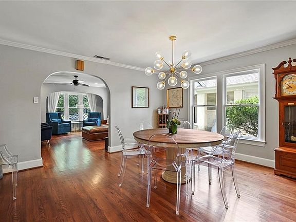 Formal Dining room with modern fixtures and note the original archway details.