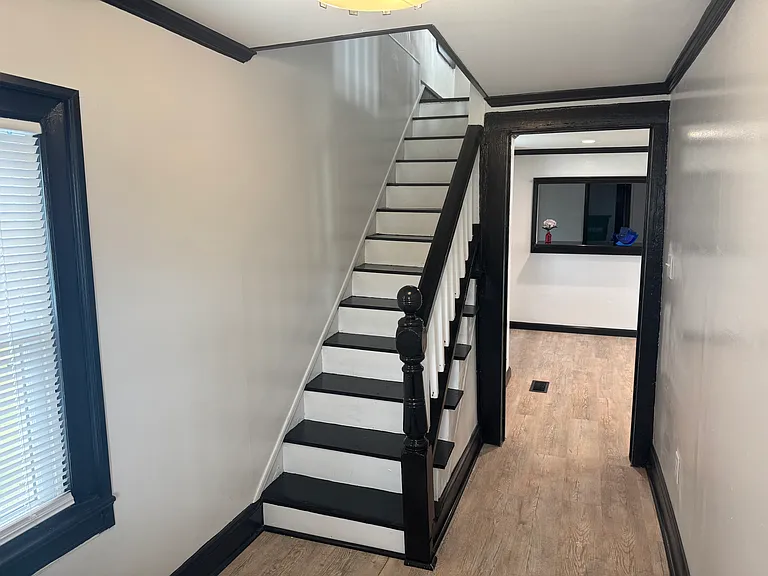 Beautiful black and white staircase leading to second floor