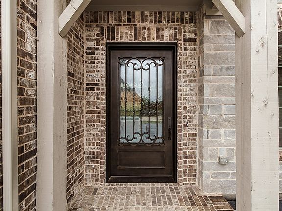 Iron and wood door at entry