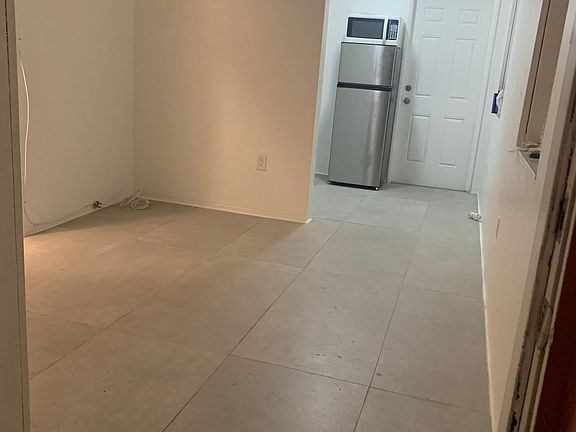 Great room leading to kitchen and rear door