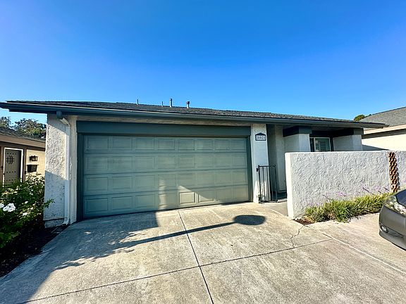 Front of Condo With Parking Pad