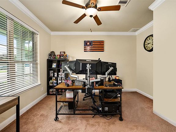 Large study with room enough for a spacious size desk, shelves, and other furniture that fits comfortably in the room.