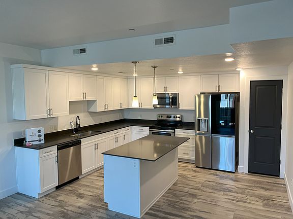 This kitchen features like-new appliances, granite countertops, ample cabinet space, and plenty of pantry space.