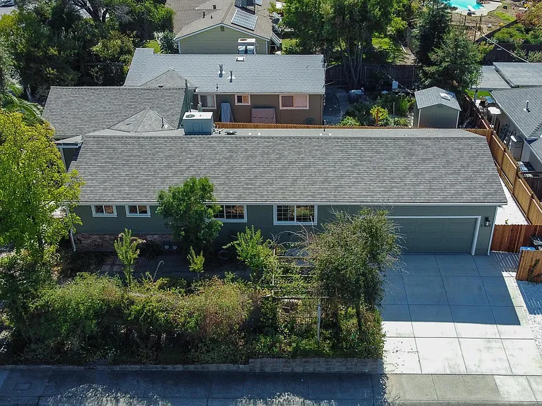Arial of property. Dark grey roof is this address/listing. Parking in front of or in garage only.