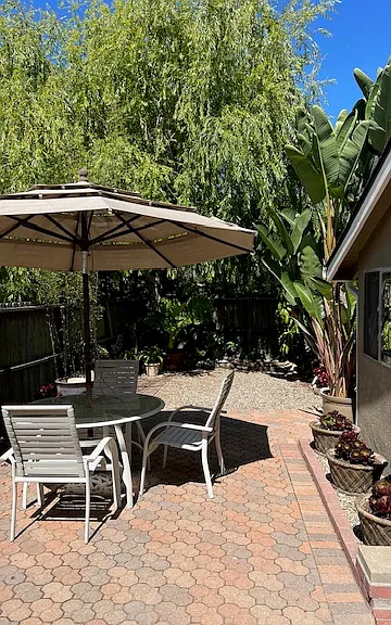 furnished with patio table, 3 chairs, and umbrella