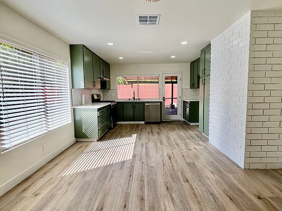 This kitchen features a fresh, modern upgrade with sleek new appliances, including a high-performance stove and energy-efficient dishwasher, all designed to make cooking and cleanup a breeze. The sink and faucet are newly installed.