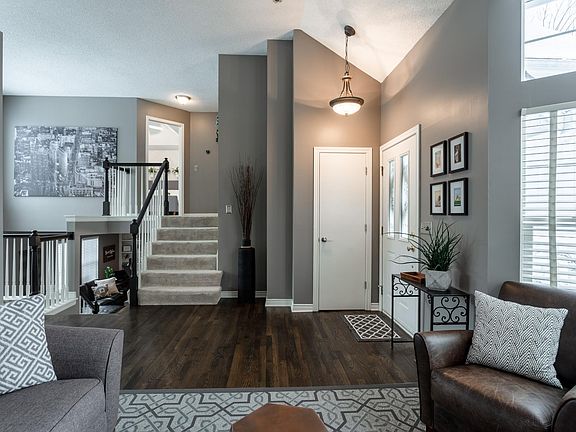 The entryway offers a coat closet and high ceilings with ample natural light.