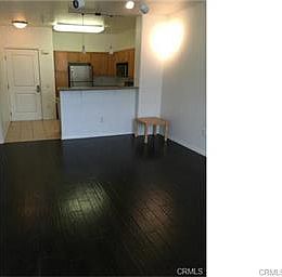 Living room facing the front door and kitchen.